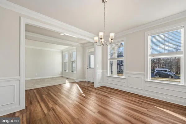 a kitchen with center island wooden floor and a window