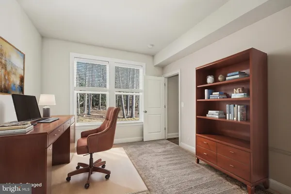 a view of a livingroom with a ceiling fan and window