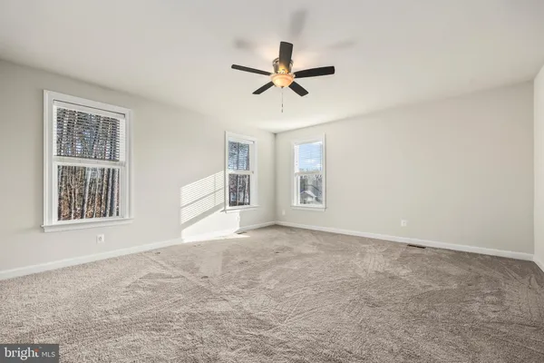 a bathroom with a granite countertop sink a toilet and a bathtub
