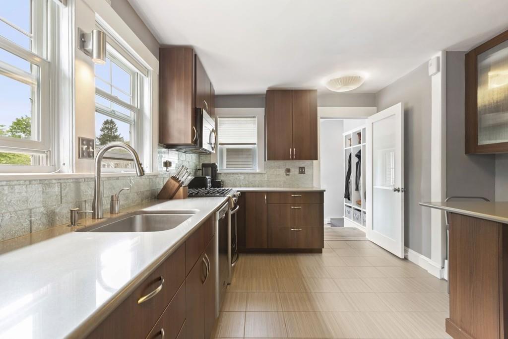 4 Bryn Mawr Road Wellesley, MA 02482 - Photo 2 of 27 a kitchen with a refrigerator sink and white cabinets