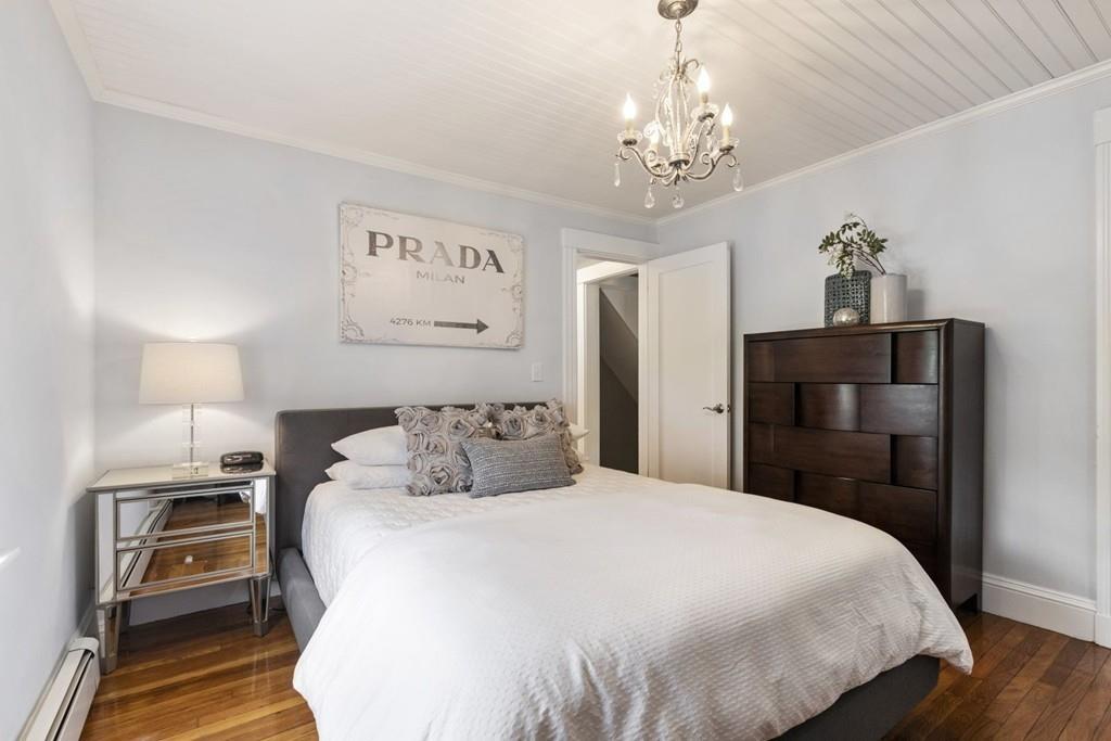 4 Bryn Mawr Road Wellesley, MA 02482 - Photo 5 of 27 a bedroom with a bed and wooden floor