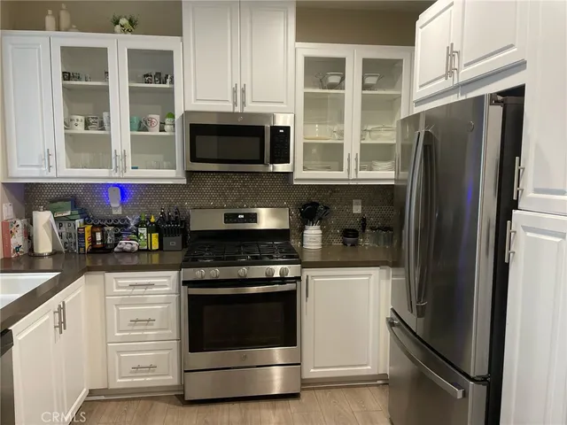 a kitchen with stainless steel appliances white cabinets and a stove