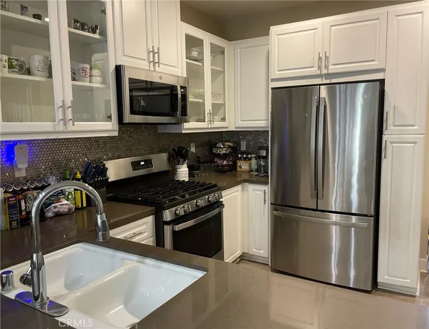 a kitchen with a refrigerator stove and microwave