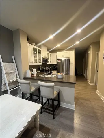 a kitchen with a sink and chairs