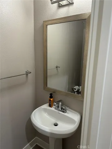 a bathroom with a sink and mirror