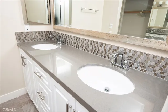 a bathroom with a granite countertop sink toilet a mirror and shower