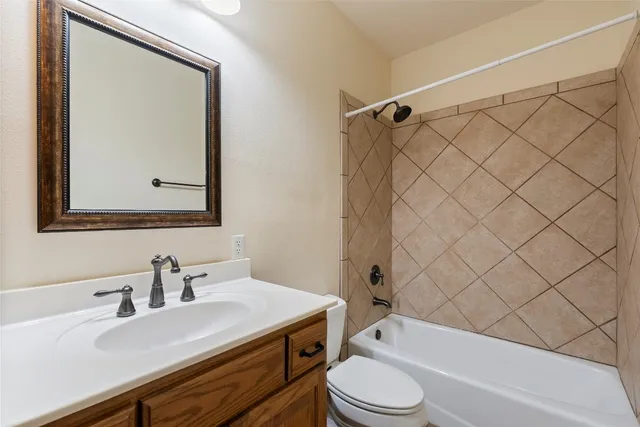 an empty room with wooden floor closet and windows