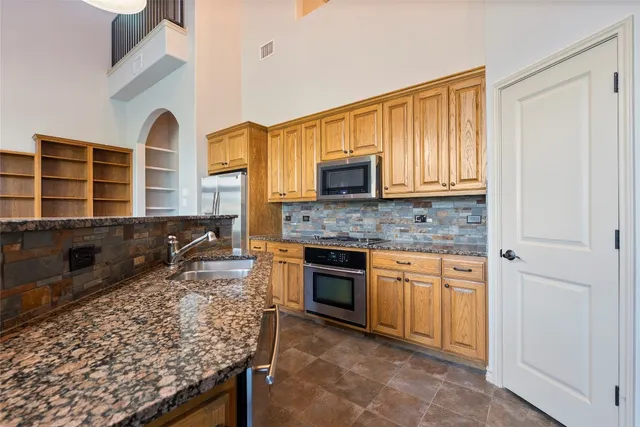 a view of a kitchen with wooden floor and a ceiling fan