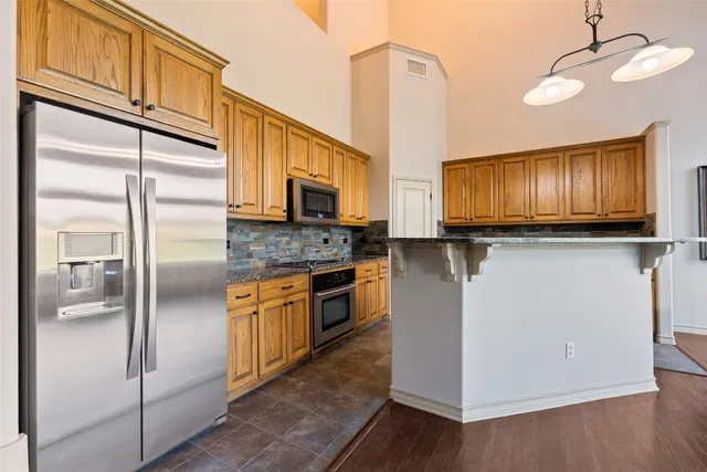 a kitchen with stainless steel appliances granite countertop a stove sink and cabinets