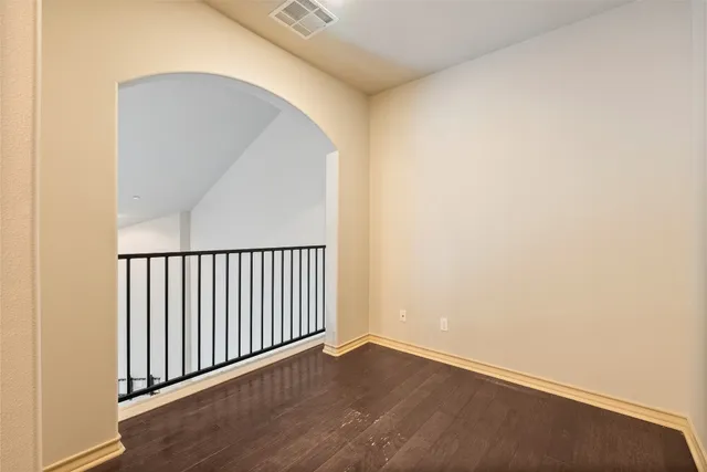 a kitchen with stainless steel appliances granite countertop a refrigerator a stove a sink and dishwasher with wooden floor