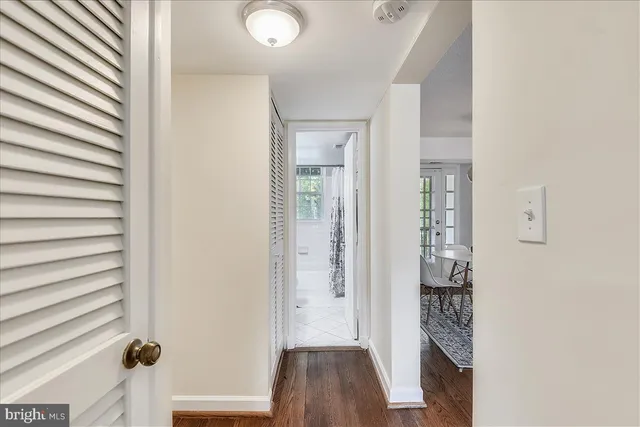 a view of a hallway with wooden floor and staircase