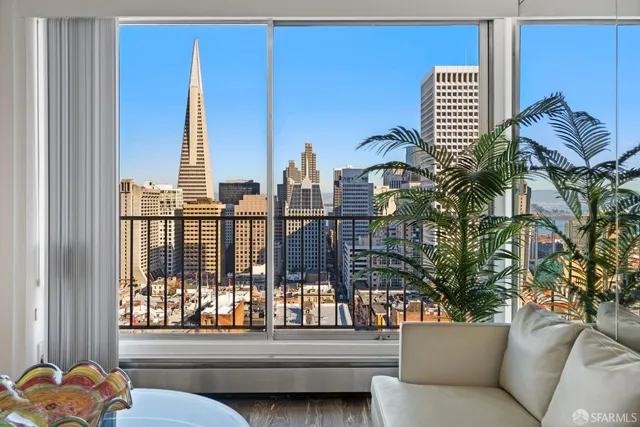 a living room with furniture potted plant and a window
