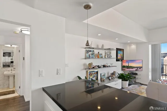 a living room with furniture a chandelier and a floor to ceiling window
