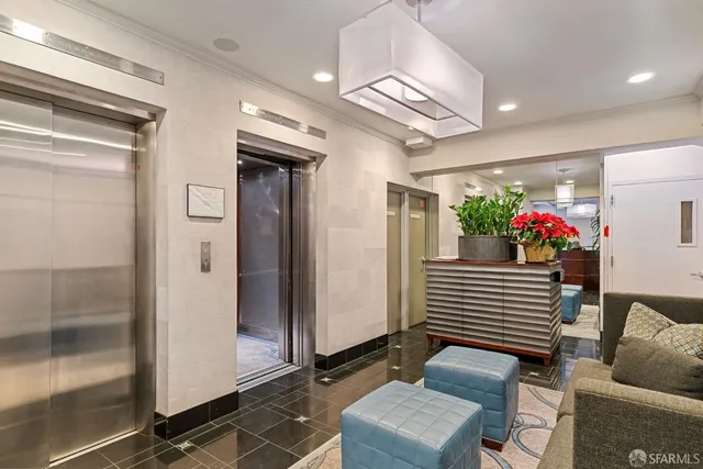 a living room with furniture and flowers