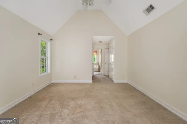 an empty room with windows and closet