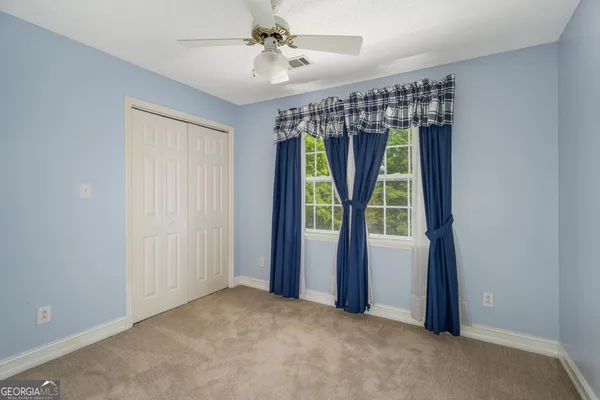 a view of a room with a large window and a rug
