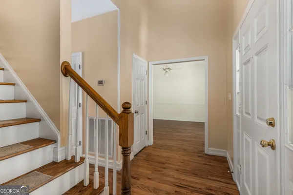 a view of an entryway with wooden floor and staircase