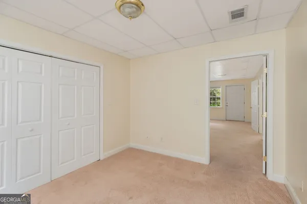 an empty room with a empty space and windows