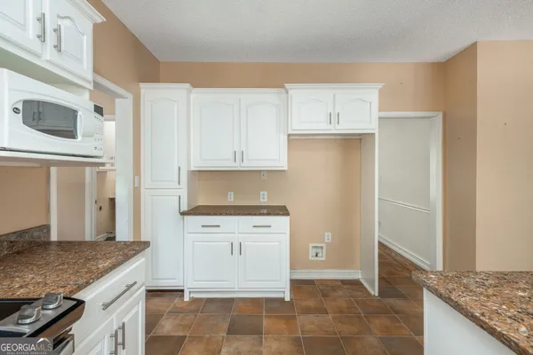 a kitchen with a stove and a microwave
