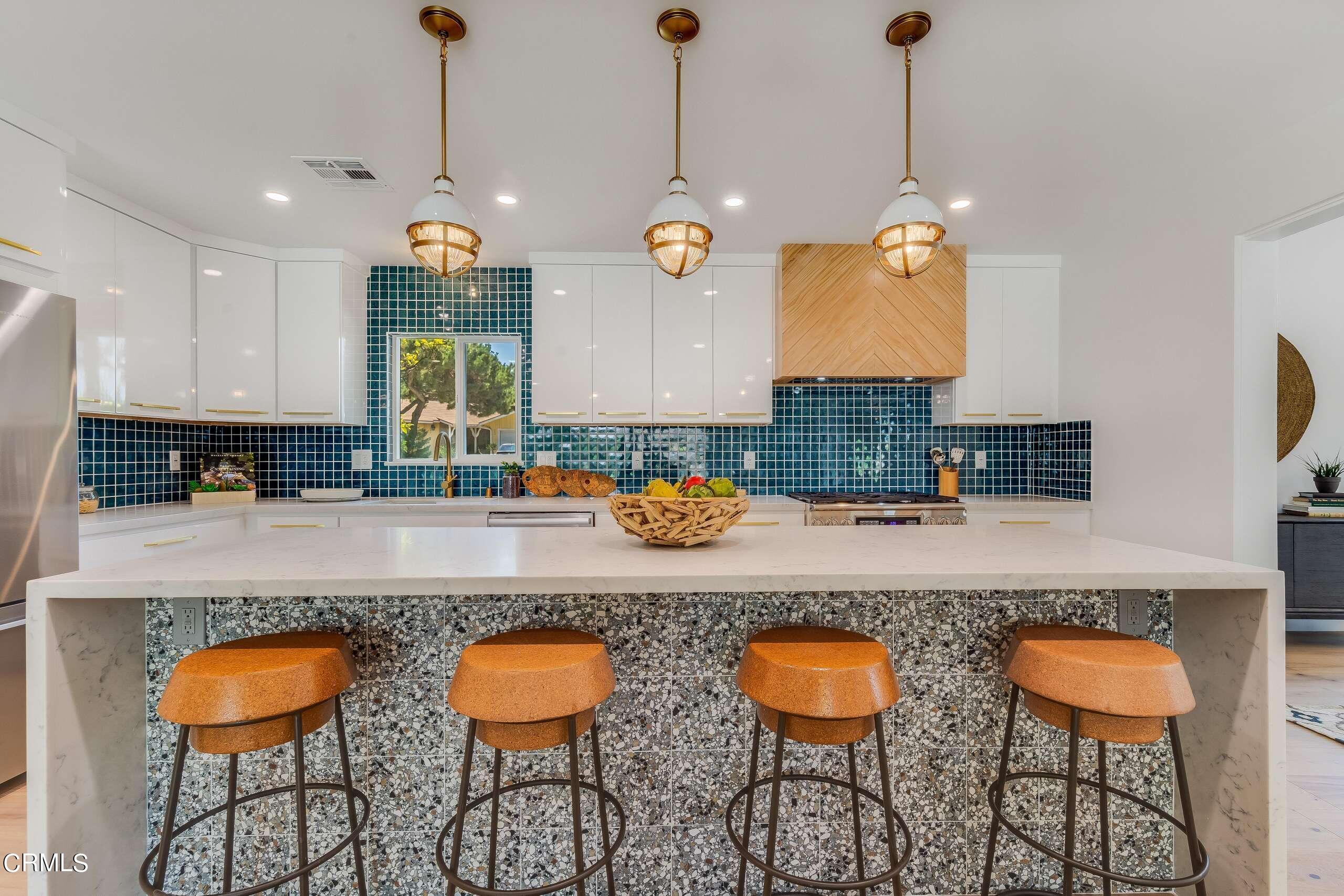 215 Highlawn Place Altadena, CA 91001 - Photo 12 of 38 a kitchen with stainless steel appliances granite countertop a stove a sink and a dining table with chairs
