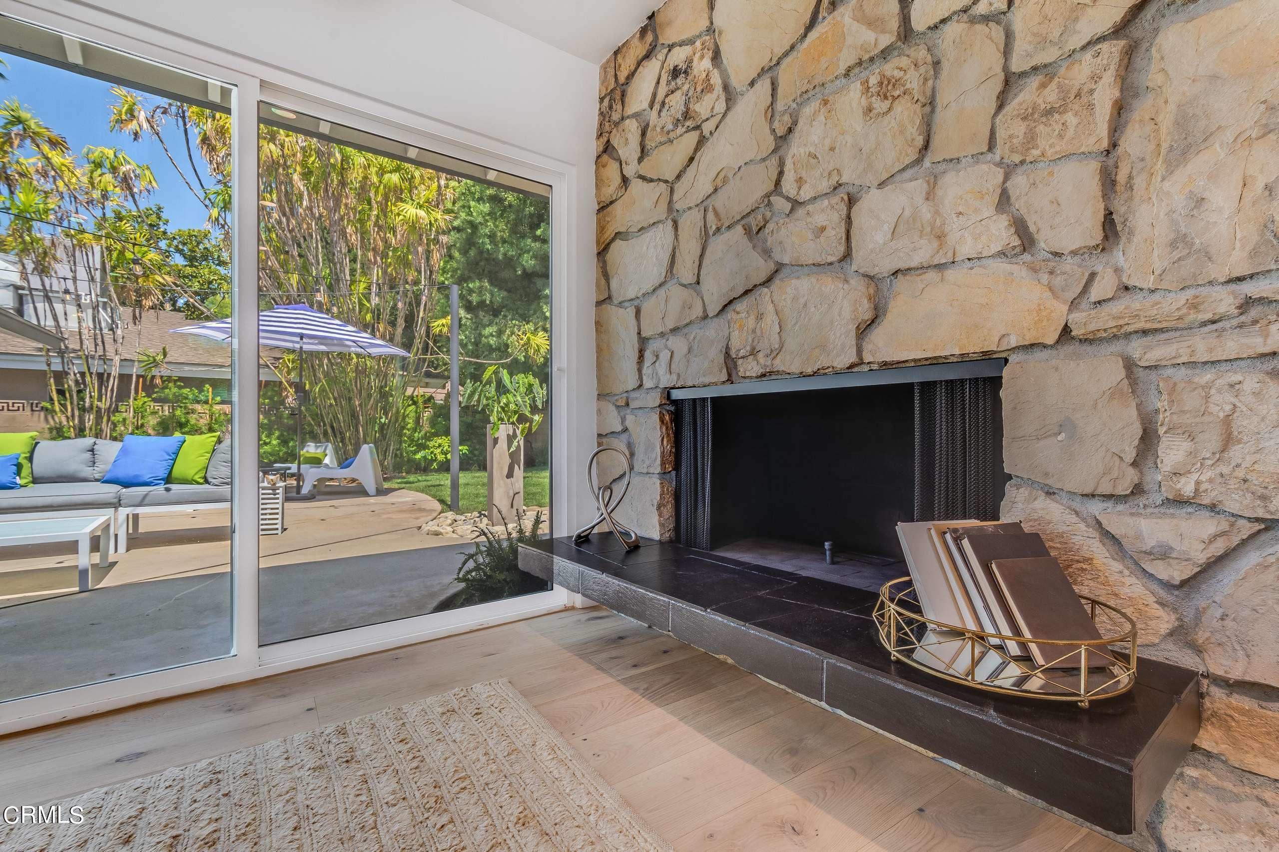 215 Highlawn Place Altadena, CA 91001 - Photo 16 of 38 a living room with fireplace furniture and a floor to ceiling window