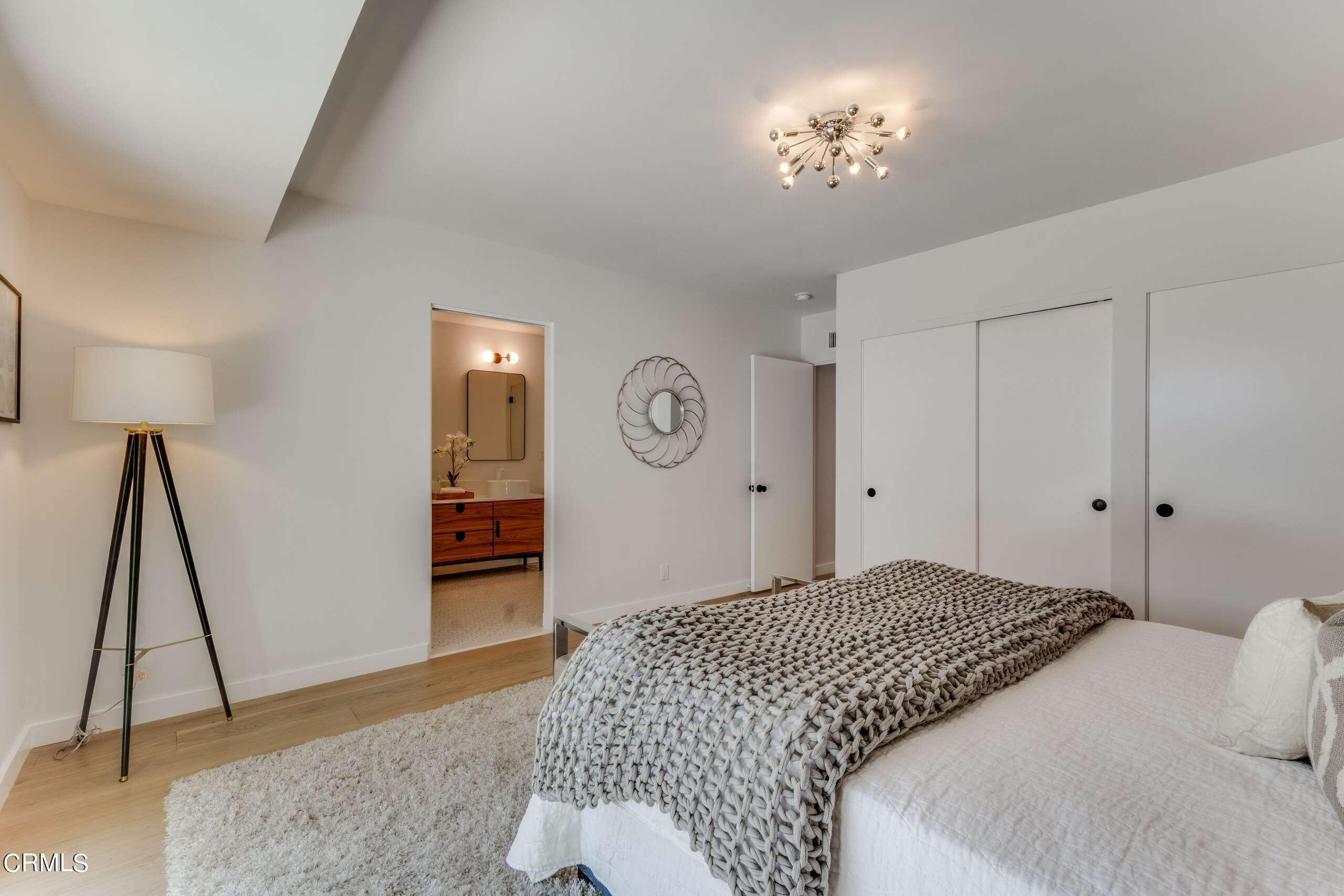 215 Highlawn Place Altadena, CA 91001 - Photo 30 of 38 a bedroom with a bed and a chandelier