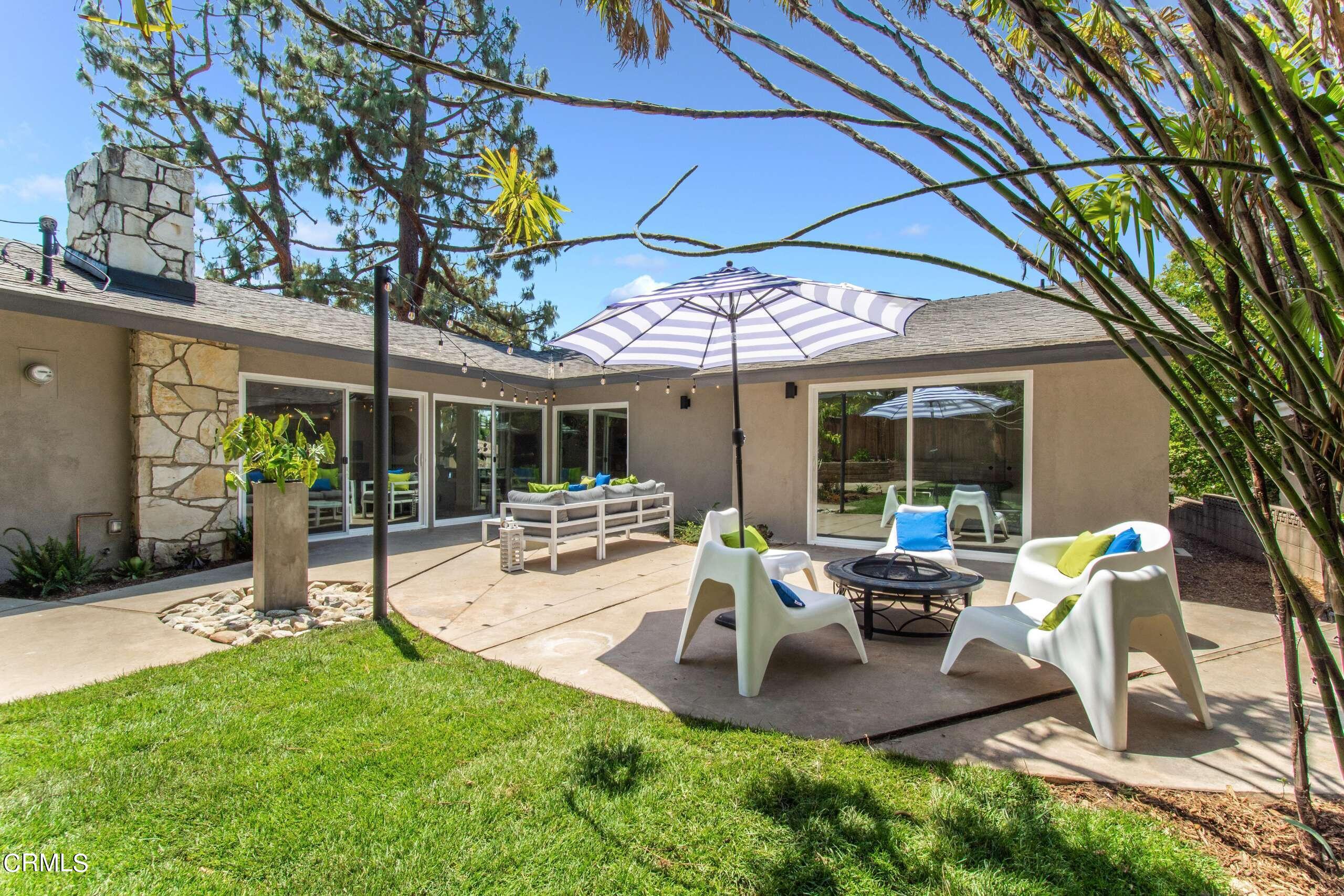 215 Highlawn Place Altadena, CA 91001 - Photo 33 of 38 a view of a patio with table and chairs under an umbrella