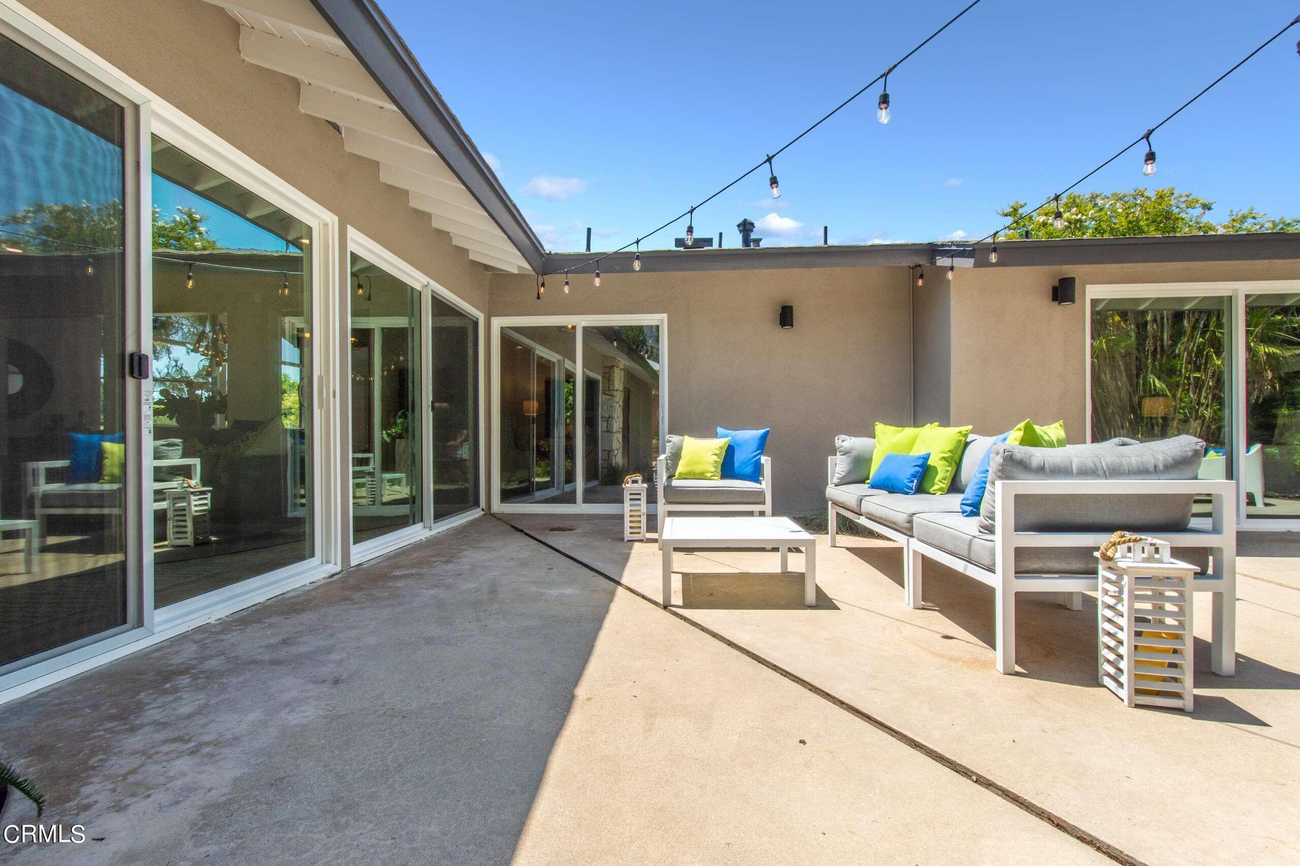 215 Highlawn Place Altadena, CA 91001 - Photo 34 of 38 a view of a patio with table and chairs potted plants