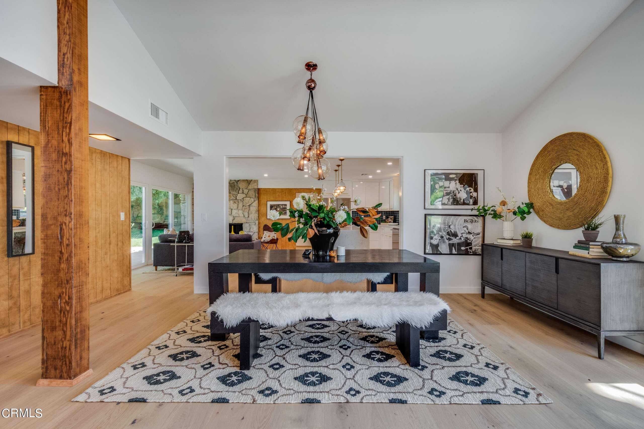 215 Highlawn Place Altadena, CA 91001 - Photo 8 of 38 a living room with a couch and a dining table with wooden floor