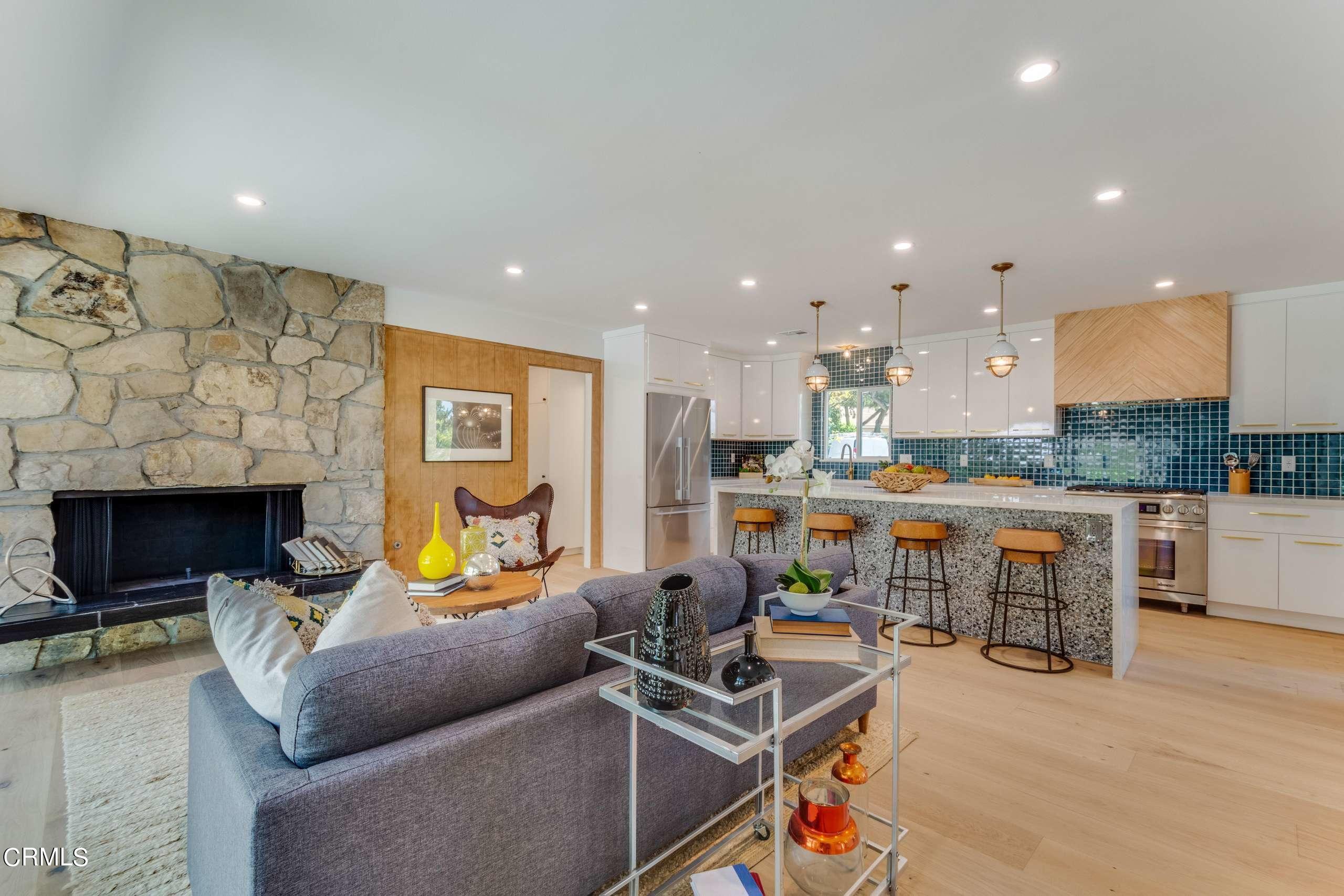 215 Highlawn Place Altadena, CA 91001 - Photo 10 of 38 a living room with furniture a fireplace and kitchen view