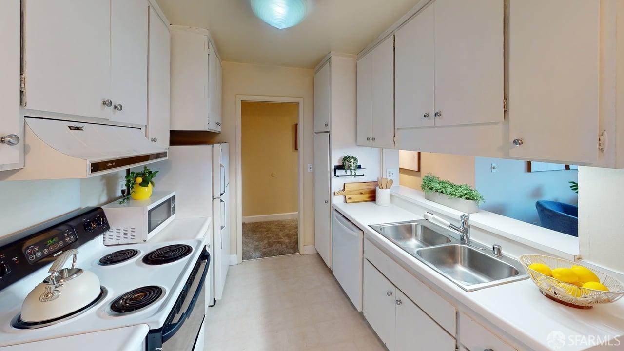 1305 Webster Street, Unit C309 Alameda, CA 94501 - Photo 11 of 24 a kitchen that has a sink and a stove in it