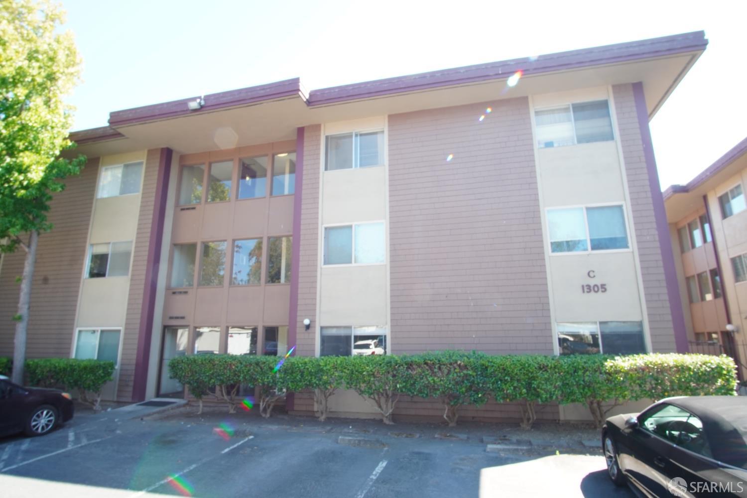 1305 Webster Street, Unit C309 Alameda, CA 94501 - Photo 22 of 24 a front view of a house with a yard