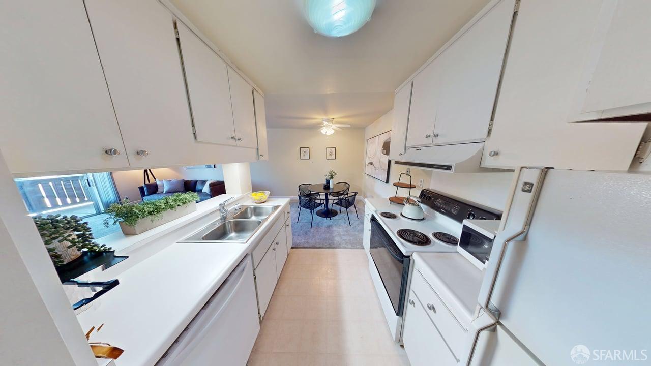 1305 Webster Street, Unit C309 Alameda, CA 94501 - Photo 4 of 24 a view of a kitchen with kitchen island wooden floor and stainless steel appliances