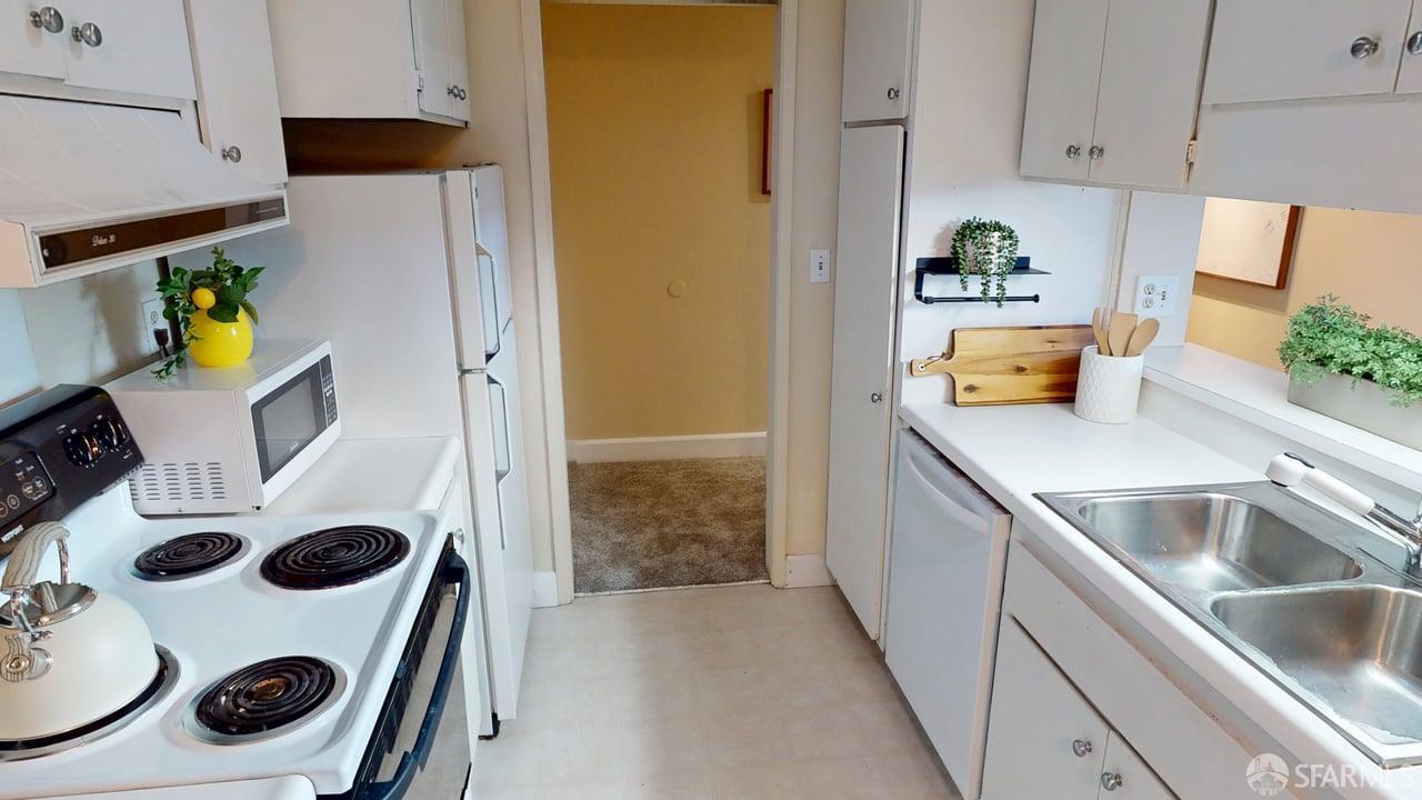 1305 Webster Street, Unit C309 Alameda, CA 94501 - Photo 5 of 24 a kitchen with a refrigerator and a stove top oven