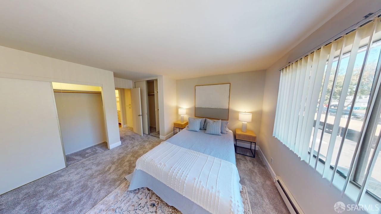 1305 Webster Street, Unit C309 Alameda, CA 94501 - Photo 6 of 24 a bedroom with a bed and wooden floor