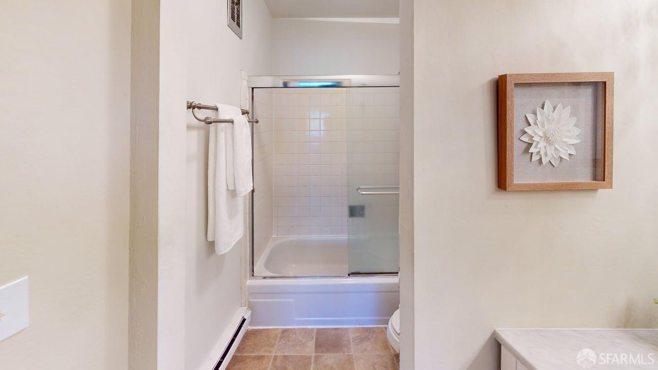 1305 Webster Street, Unit C309 Alameda, CA 94501 - Photo 8 of 24 a bathroom with a glass shower door
