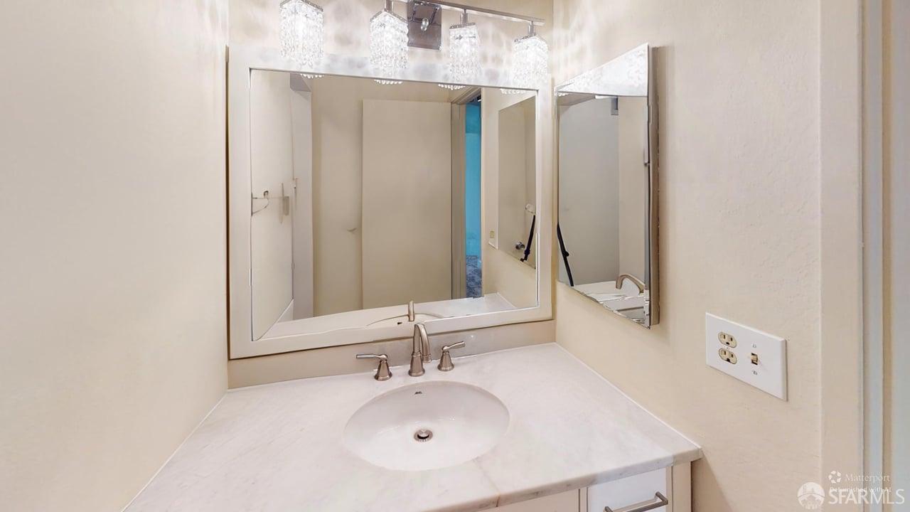 1305 Webster Street, Unit C309 Alameda, CA 94501 - Photo 10 of 24 a bathroom with a sink and a mirror