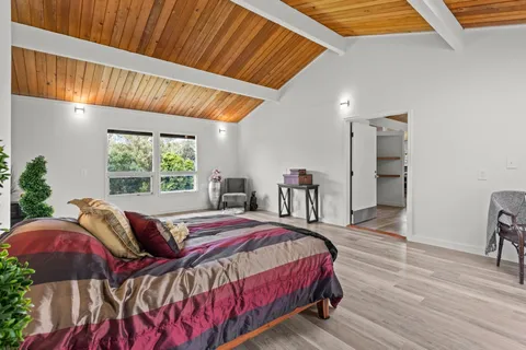 a bedroom with a bed and a mirror