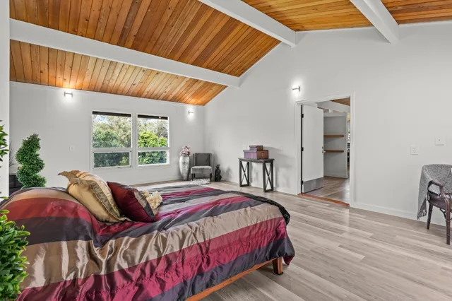 a bedroom with a bed and a mirror