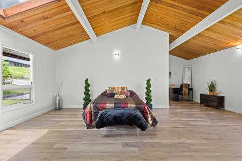 a bedroom with a bed and a large window