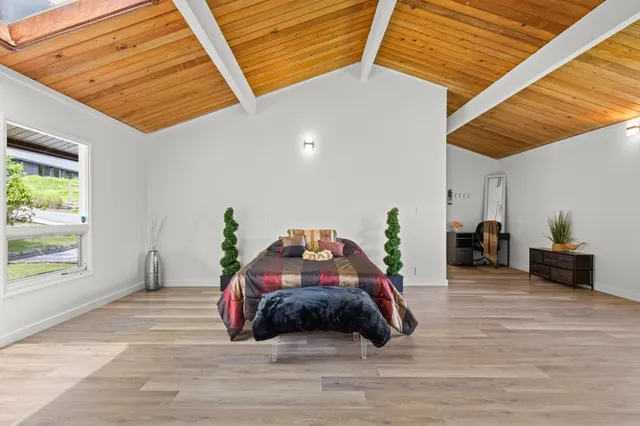 a bedroom with a bed and a large window