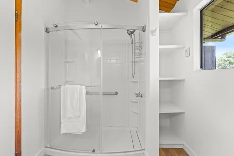a bathroom with a glass shower door