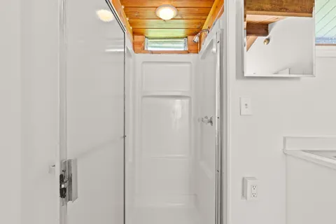 a bathroom with a window and a shower