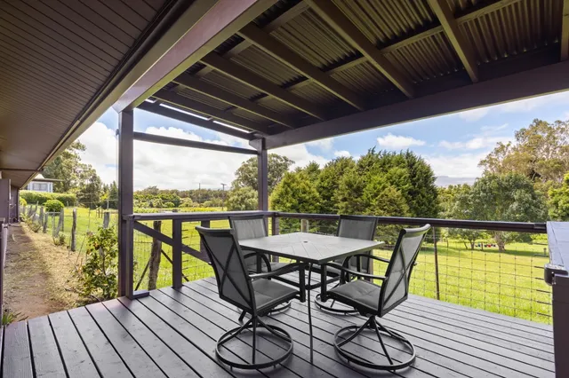 a view of a chairs and table on the balcony