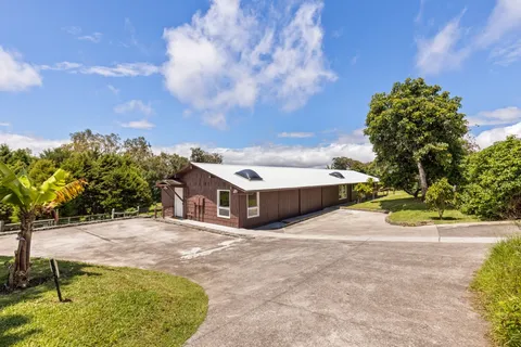 a view of an chairs and table in the backyard
