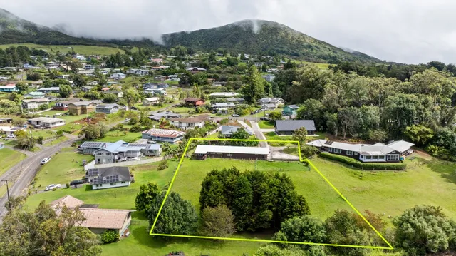 an aerial view of residential houses with outdoor space and swimming pool