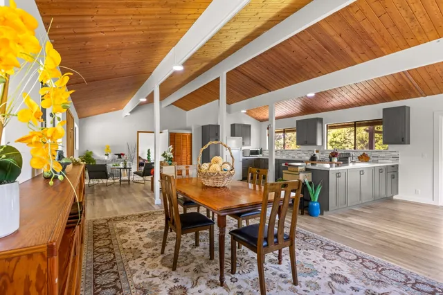 a dining room with furniture and a clock
