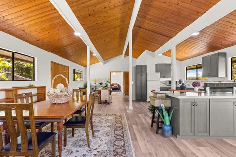 a dining room with furniture and wooden floor