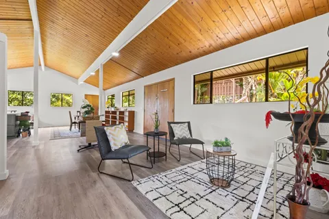 a dining room with furniture and wooden floor