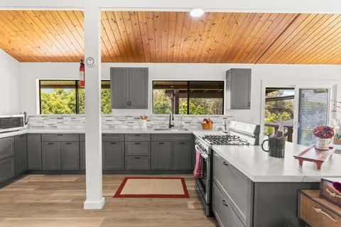 a spacious bathroom with a sink mirror and window